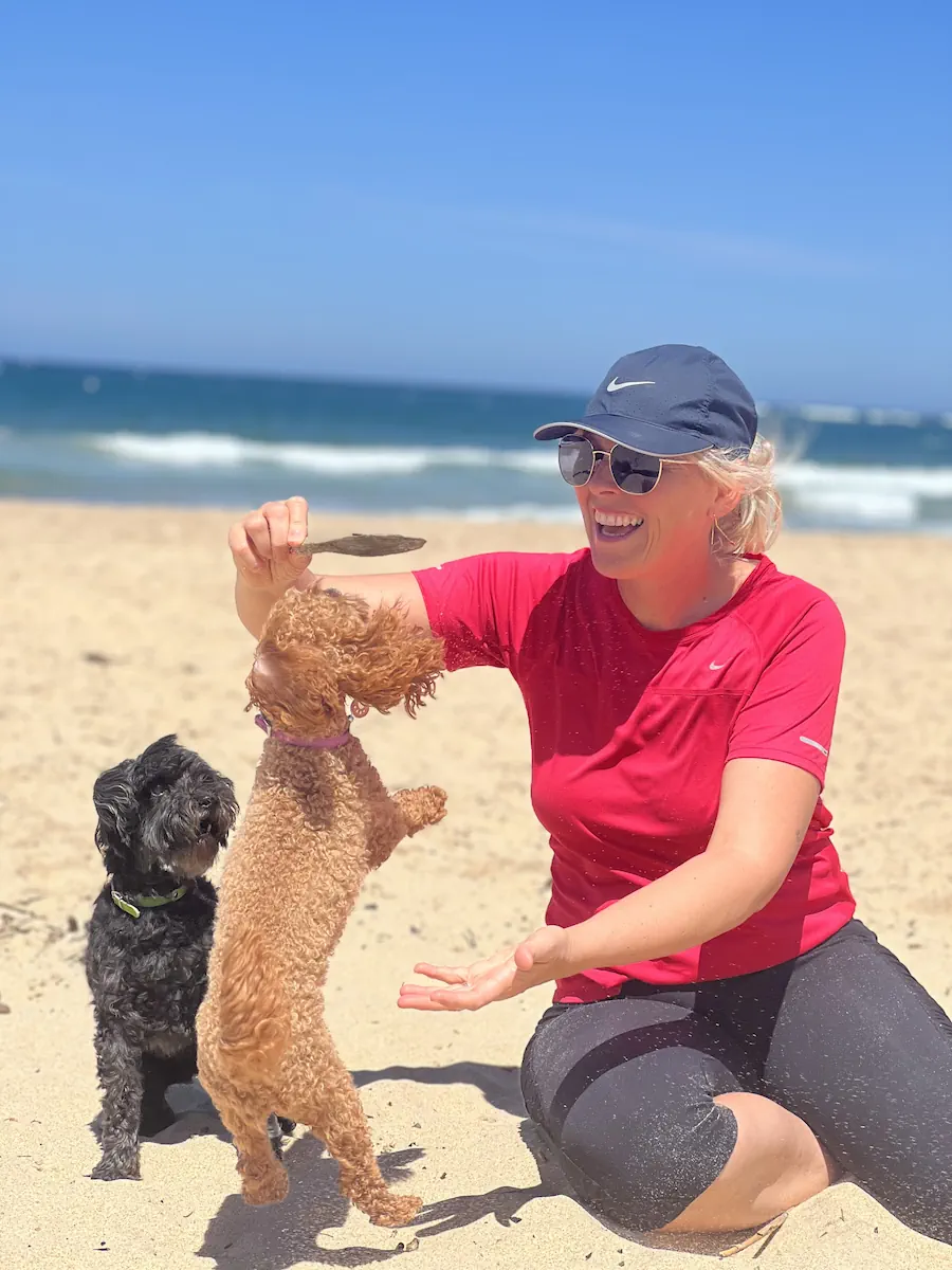 Rani at the beach with her two dogs